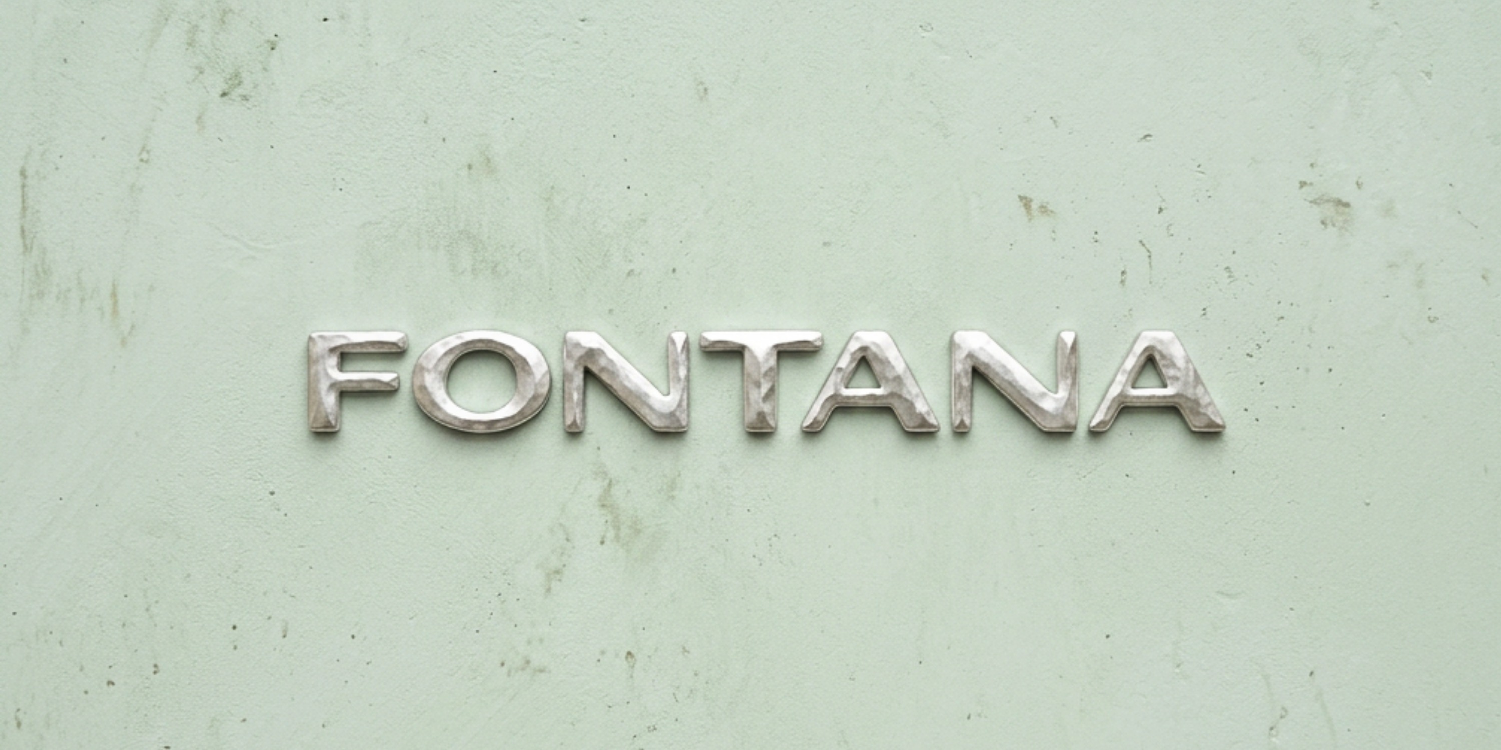 FONTANA in cast silver letters on a patina wall